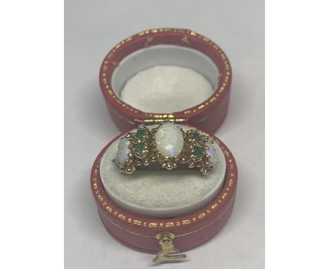 A 9 CARAT GOLD GOLD RING WITH OPALS AND EMERALDS SIZE L IN A PRESENTATION BOX 