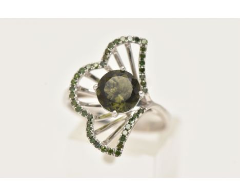 A 14CT WHITE GOLD GEM SET RING, set with a central circular cut green stone assessed as paste, claw set within an open work s