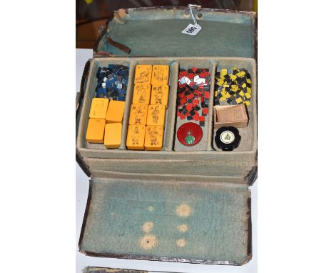 A CHINESE MAHJONG SET, early 20th century, with plastic tiles, the leather case with hinged lid revealing five removable tray