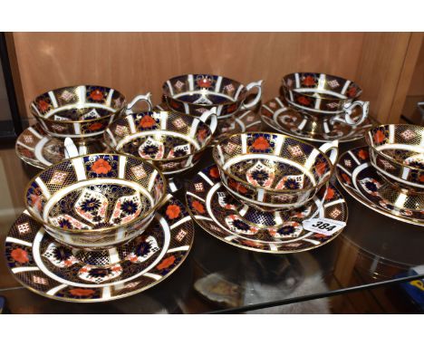 A GROUP OF ROYAL CROWN DERBY OLD IMARI TEACUPS AND SAUCERS in pattern 1128, comprising seven teacups and six saucers, three w