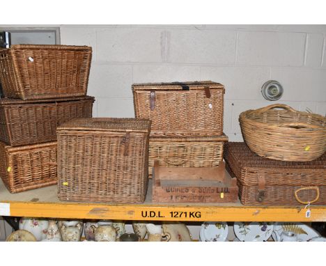 A QUANTITY OF WICKER HAMPERS AND BASKETS, comprising seven large hampers and a circular basket, some leather fastening straps