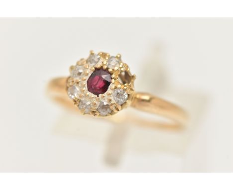 A RUBY AND DIAMOND CLUSTER RING, designed as a central oval shape ruby within an old cut diamond surround, to the pinched sho