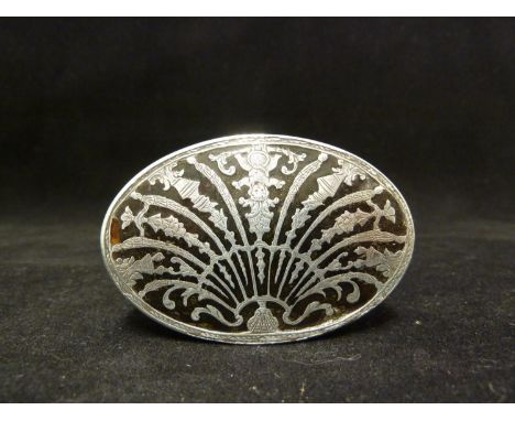A silver pique work snuff box, oval decorated with a scallop shell form motif the ribs formed as floral swags, vases and a ch