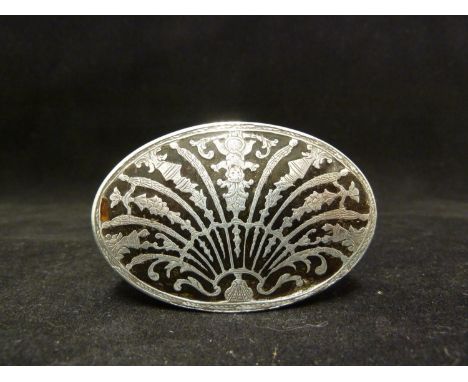 A silver pique work snuff box, oval decorated with a scallop shell form motif the ribs formed as floral swags, vases and a ch