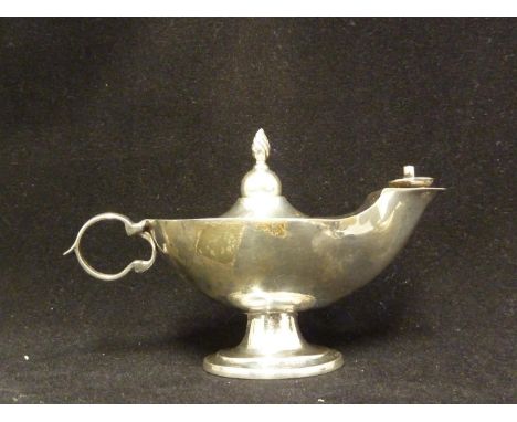 A silver cigar lighter in the form of an oil lamp, Birmingham 1909, makers mark MJJ for Matthew John Jessop; and four ashtray