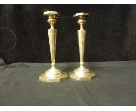 A pair of American Sterling silver Art Deco candlesticks, each with octagonal foot and detachable sconce on a tapered octagon