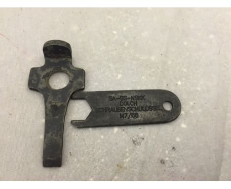 A German WWII Luger pistol strip down tool and a dagger (SA/SS/NSKK) top nut spanner, both WWII marked