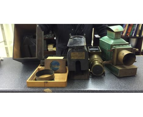 A vintage Magic Lantern with slides and glass plates of horses ploughing, farming etc