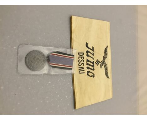 A German WWII Luftslutz air raid medal and "Junes" engine factory armband