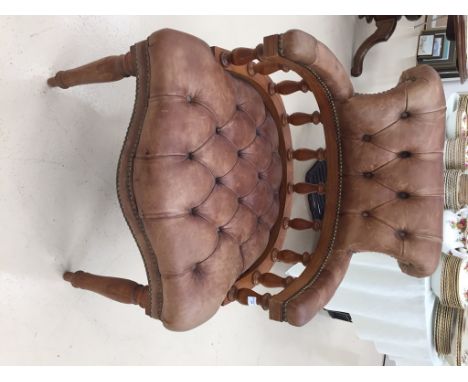 A Captain's chair with leather button back