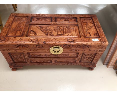 A carved oriental wooden trunk