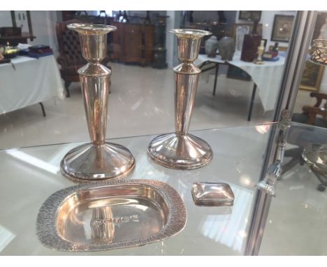 A pair of HM silver candlesticks; together with a silver tray (1977) and a pill box