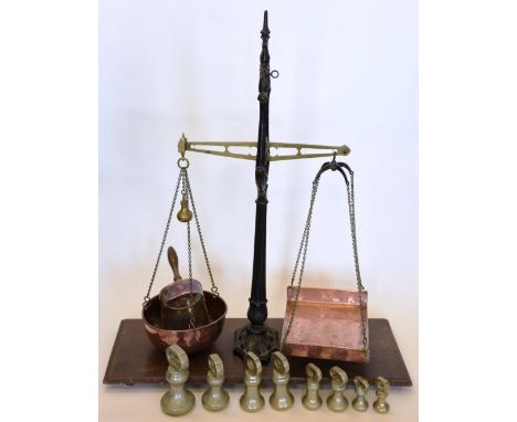 A set of 19th century brass and wrought iron scales with brass chains and copper pans, on an oak plinth base.  34ins wide tog