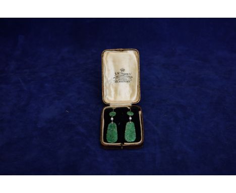 A pair of jade earrings with circular bosses above a single pearl and a diamond set clasp above an oval jade panel.  Est £100