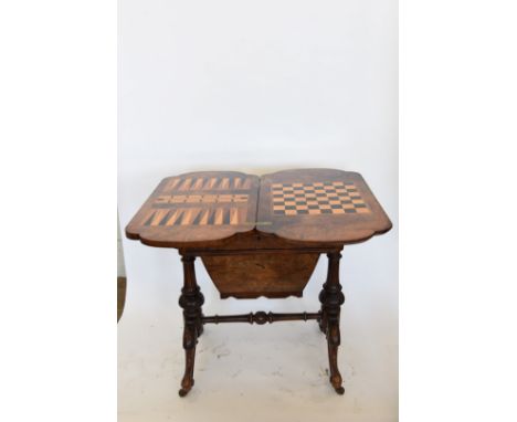 A Victorian walnut and boxwood strung sewing / games table, the hinged lid opening to reveal a chess board, a back gamMon boa