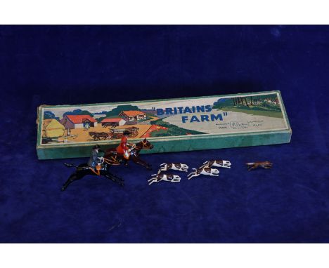 A boxed Britains hunting set ‘Full Cry’ comprising a huntsman and huntswoman on horseback, two huntsmen on foot, seven hounds