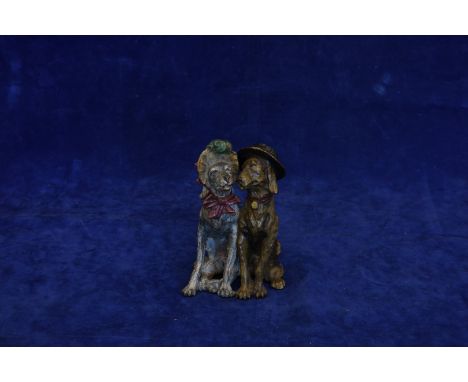 A cold painted bronze figure of two seated dogs depicted wearing a gentleman’s hat and a ladies bonnet.  Est £400-600  