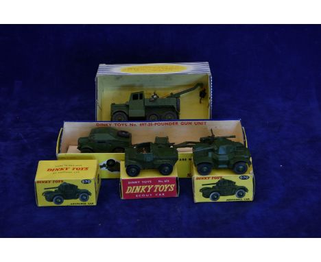 A Dinky Super Toys 661 recovery tractor, a Dinky Toys 697 twenty five pounder field gun set, a Dinky Toys 673 scout car with 