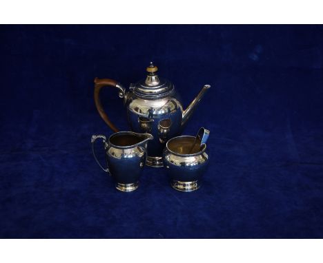 An Edward VIII silver three piece coffee set comprising coffee pot with turned fruitwood handle and finial and gadrooned rim,