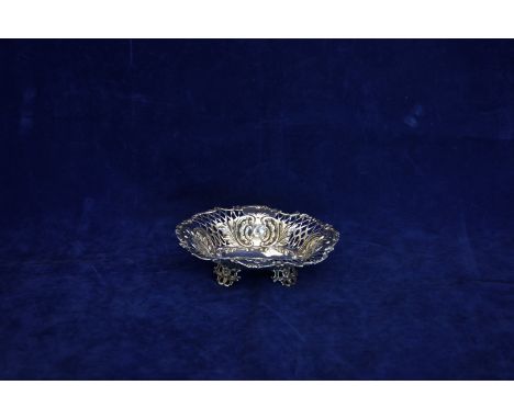 A late Victorian silver basket with flower head and scroll cast border, pierced lower section interspersed by cartouches of r