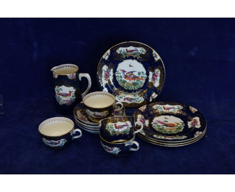 A Booths silicon china tea set decorated with exotic birds in a landscape, on a blue speckled ground with gilt borders compri