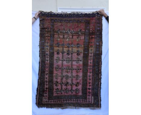 An Afghan Zekani Dozar carpet, the puce ground with multiple arrow decorated borders and tasselled ends.  72 by 48ins.  Est £