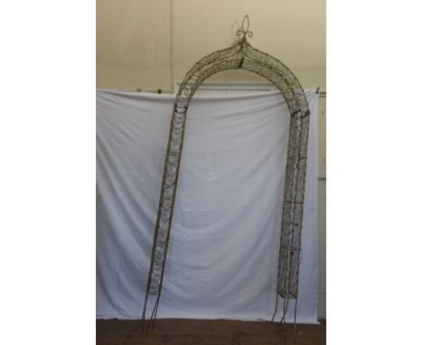 A wirework garden arch with pierced fleur-de-lis style pediment.  40ins wide by 96ins.  Est £30-50