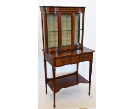 An Edwardian walnut, boxwood, ebony and satinwood banded side cabinet with serpentine front glazed cupboard doors to the uppe