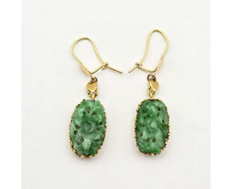 A pair of carved Jade Ear Pendants, claw-set jade panels carved in stylised foliage form suspended from wire safety hooks, st