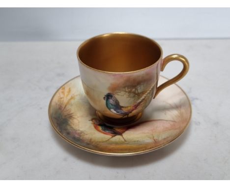 A Royal Worcester Coffee Cup and Saucer painted Asiatic pheasant in landscape