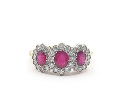 A Ruby and Diamond Dress Ring, three oval mixed-cut rubies surrounded by pavé-set single cut diamonds in cluster settings set