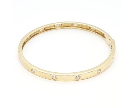 A hinged yellow metal Bangle set cz, stamped 14K, approx 15.6gms
