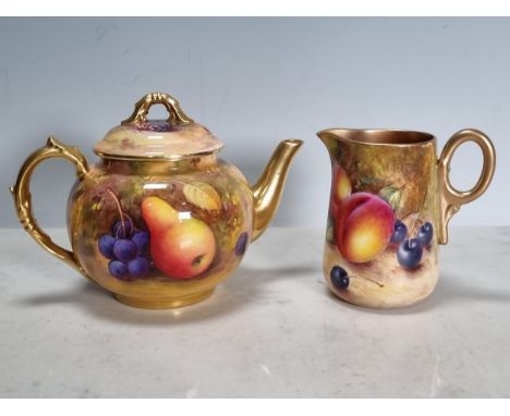 A Royal Worcester fruit painted Teapot and Cover, apples, pears, and berries, signed 'Shuk', and a similar Jug, signed 'Freem
