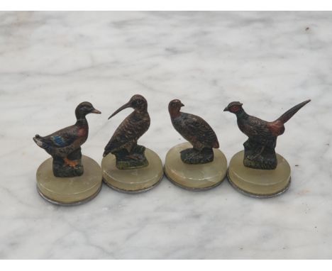 Four cold painted bronze Menu Holders in the form of pheasant, duck, partridge and woodcock, on circular onyx bases