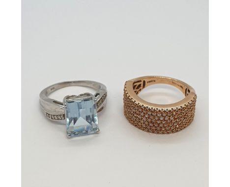 An Aquamarine and Diamond Dress Ring in 18ct white gold and a pavé-set half hoop Diamond Dress ring in 18ct rose gold, both r