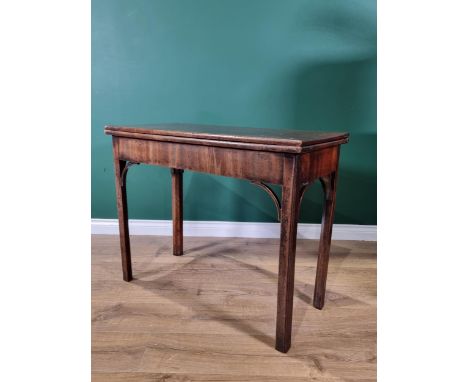 A Georgian mahogany Card Table with foldover rectangular top, supported on a concertina action and raised on chamfered square