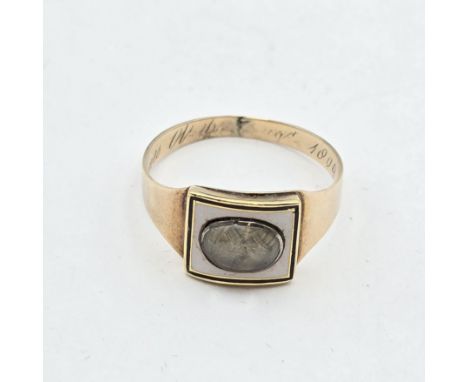 A Georgian Mourning Ring having plaited hair set into white and black enamel panel, engraved within 'E Ditcher died 6 May 180