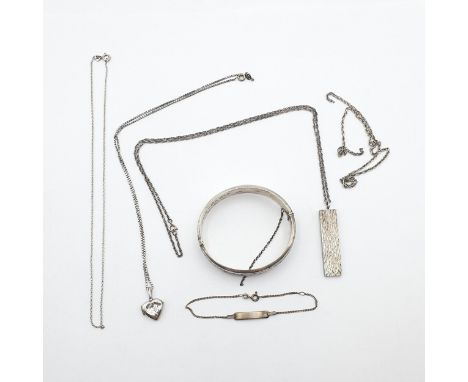 A small group of Silver Jewellery to include a vintage engraved Silver Bangle, a Silver Ingot on chain, three further Necklac