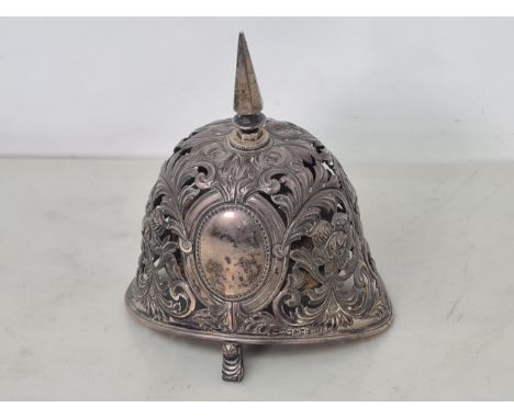 An Unusual Victorian silver Table Bell in the form of a pickle helmet with floral and scroll piercing, vacant oval cartouches