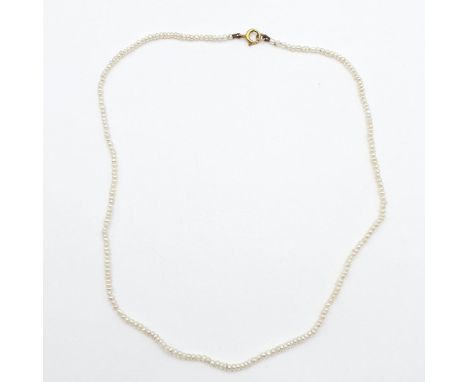 A Seed Pearl Necklace on a bolt-ring clasp stamped 9ct, 36cm long
