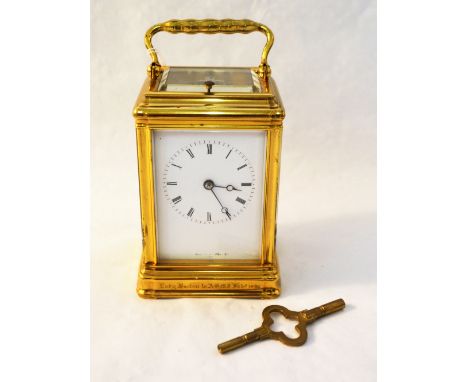 A brass carriage clock with presentation inscription from Lady Buxton and date 1865