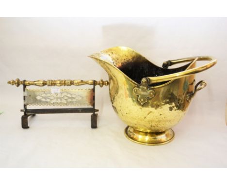 A 19th Century pierced brass fender, 36" wide, a Georgian brass and iron hanging trivet plus a brass coal helmet