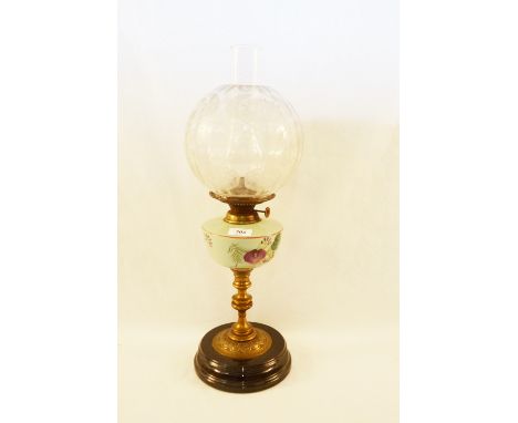 A brass column oil lamp with floral opal glass bowl and etched globe