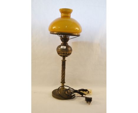 A brass lamp with glass shade
