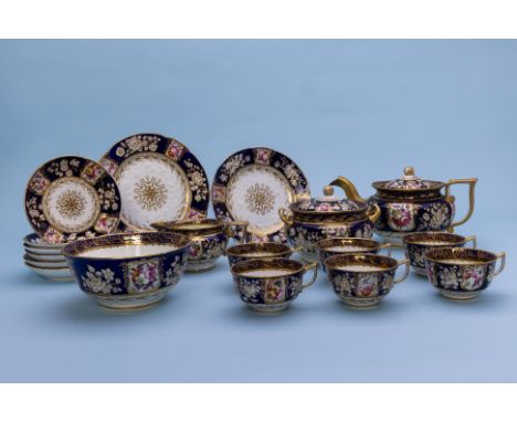 A COALPORT PART TEA SERVICE
Circa 1840
Moulded and richly decorated with panels of flowers, gilt and cobalt blue borders 
Com