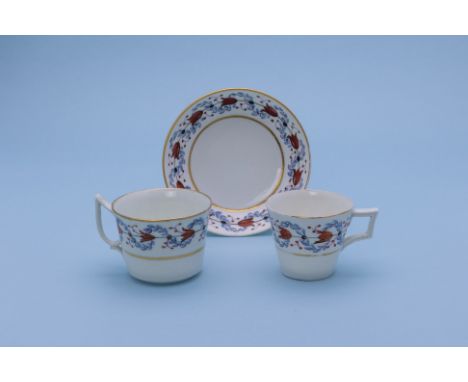 A GROUP OF THREE TRIOS
A Crown Derby example, circa 1810, red painted marks, decorated with a band of blue and gilt foliage; 