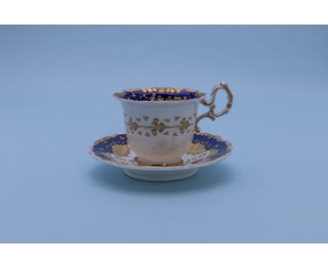 A GROUP OF THREE CUPS AND SAUCERS
Early 19th Century, circa 1820-40
A coffee cup and saucer painted with flowers within elabo