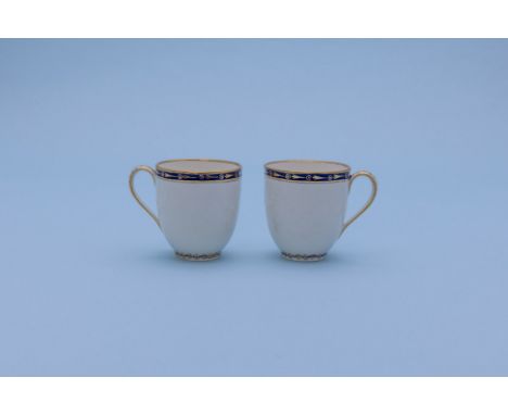 A PAIR OF CROWN DERBY COFFEE CUPS
Late 18th Century, puce painted marks
Moulded with swags and decorated with blue and gilt b