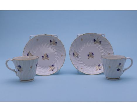 A PAIR OF BARR WORCESTER COFFEE CUPS AND SAUCERS
Circa 1800
Spirally fluted and decorated with floral sprigs, incised 'B' mar