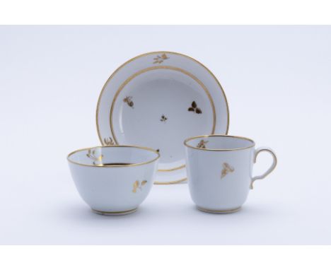 THREE ROYAL WORCESTER AND OTHER TRIOS
Comprising:
A Barr Worcester trio, with a band of trailing foliage, circa 1800, incised